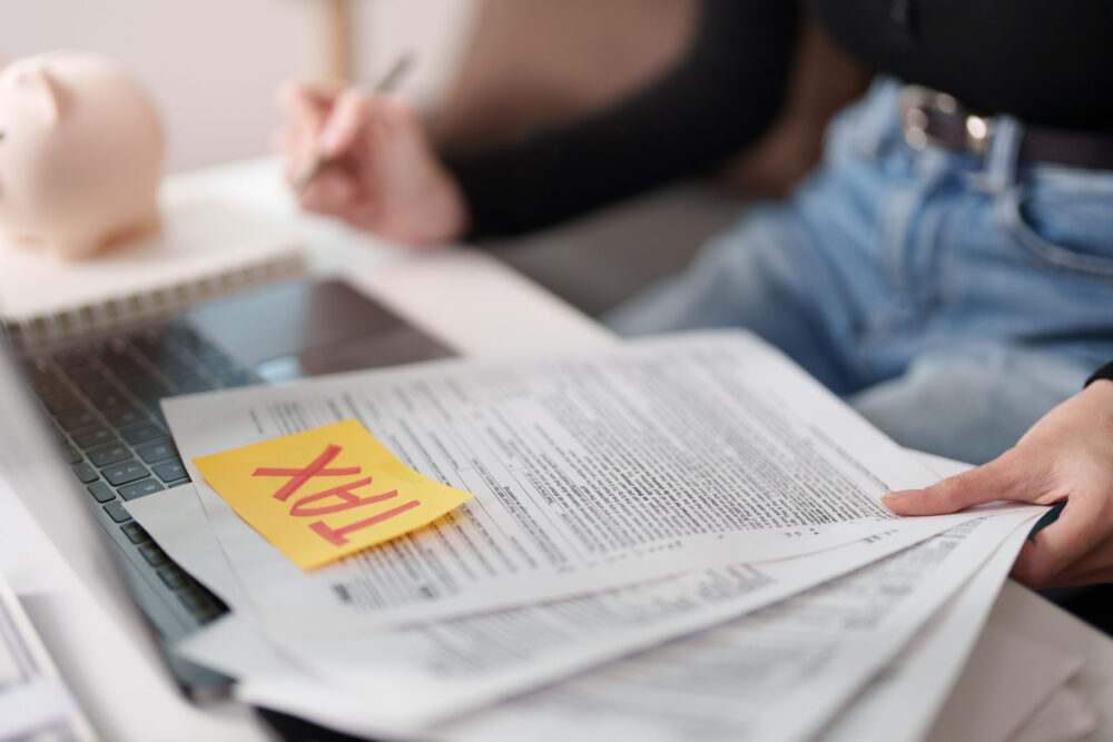 tax form paperwork with yellow sticky note on desk for income tax return filing